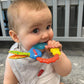 Nuby Wacky Teething Ring – Multi - Texture Silicone & Ribbon Teether for Infants, 4+ Months, Stimulates Gums & Senses - Adenzo Comfies